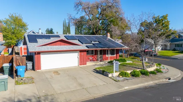 an aerial view of a house with a yard and a garage