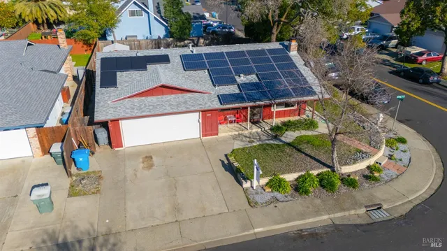 a view of a house with a potted plant ana a small yard