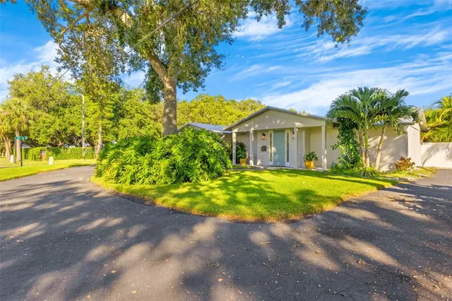 a view of yellow house with a yard