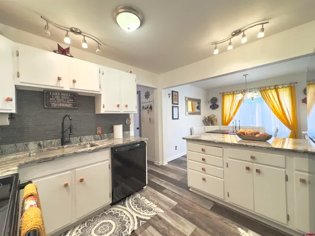 a kitchen with a sink window and cabinets