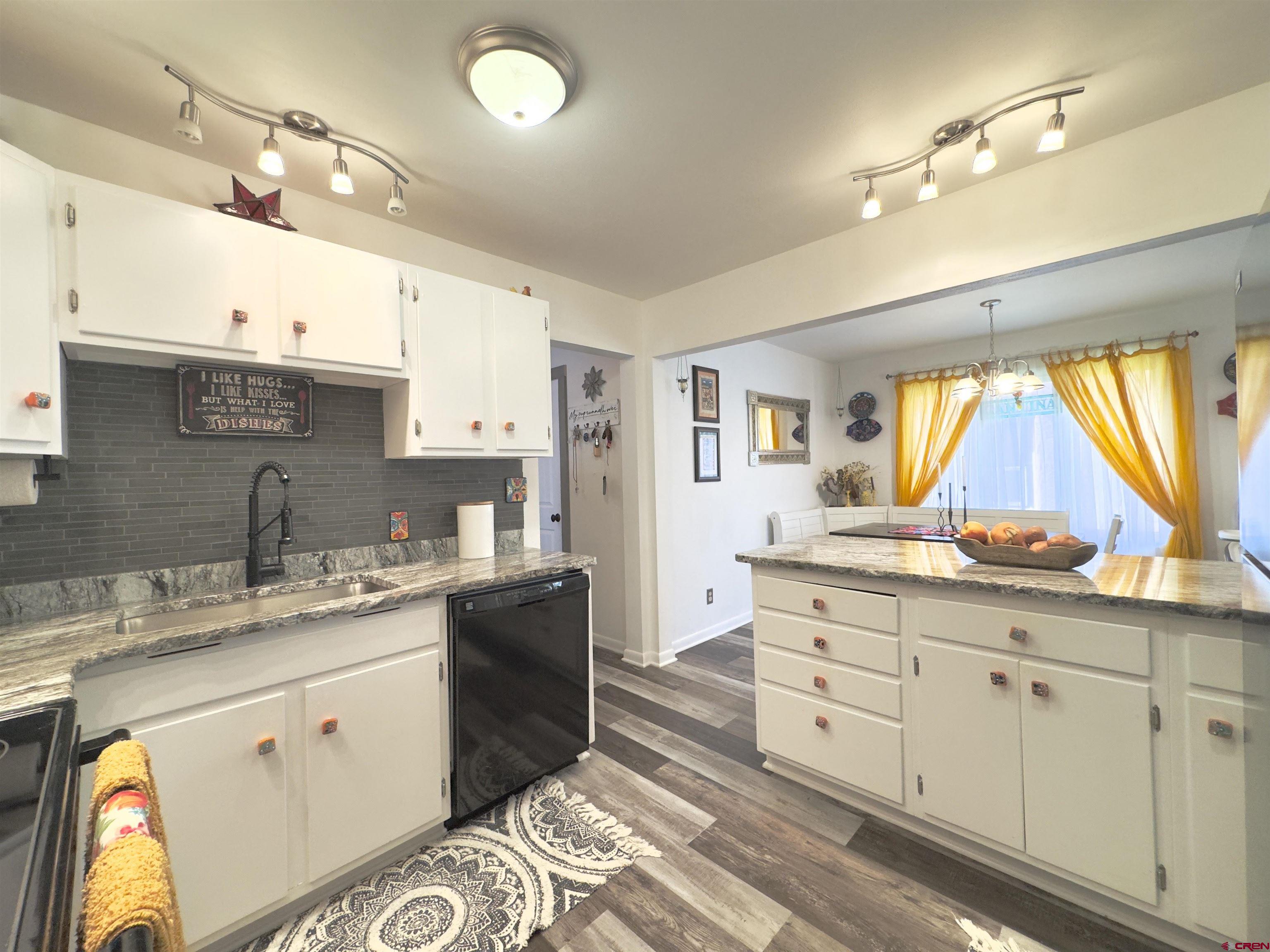 660 Columbia Avenue Del Norte, CO 81132 - Photo 12 of 31 a kitchen with a sink window and cabinets