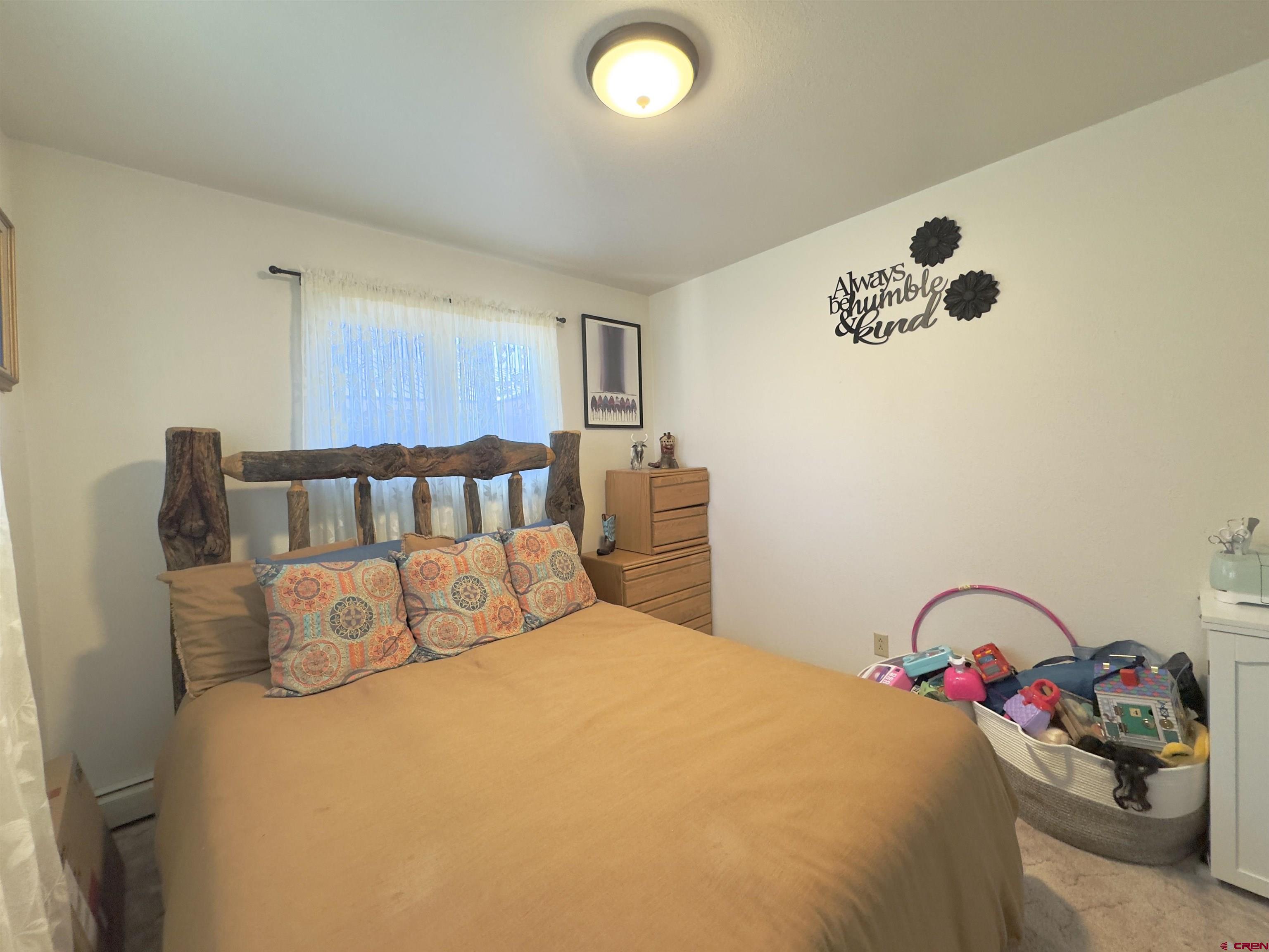 660 Columbia Avenue Del Norte, CO 81132 - Photo 13 of 31 a bedroom with a bed and a window