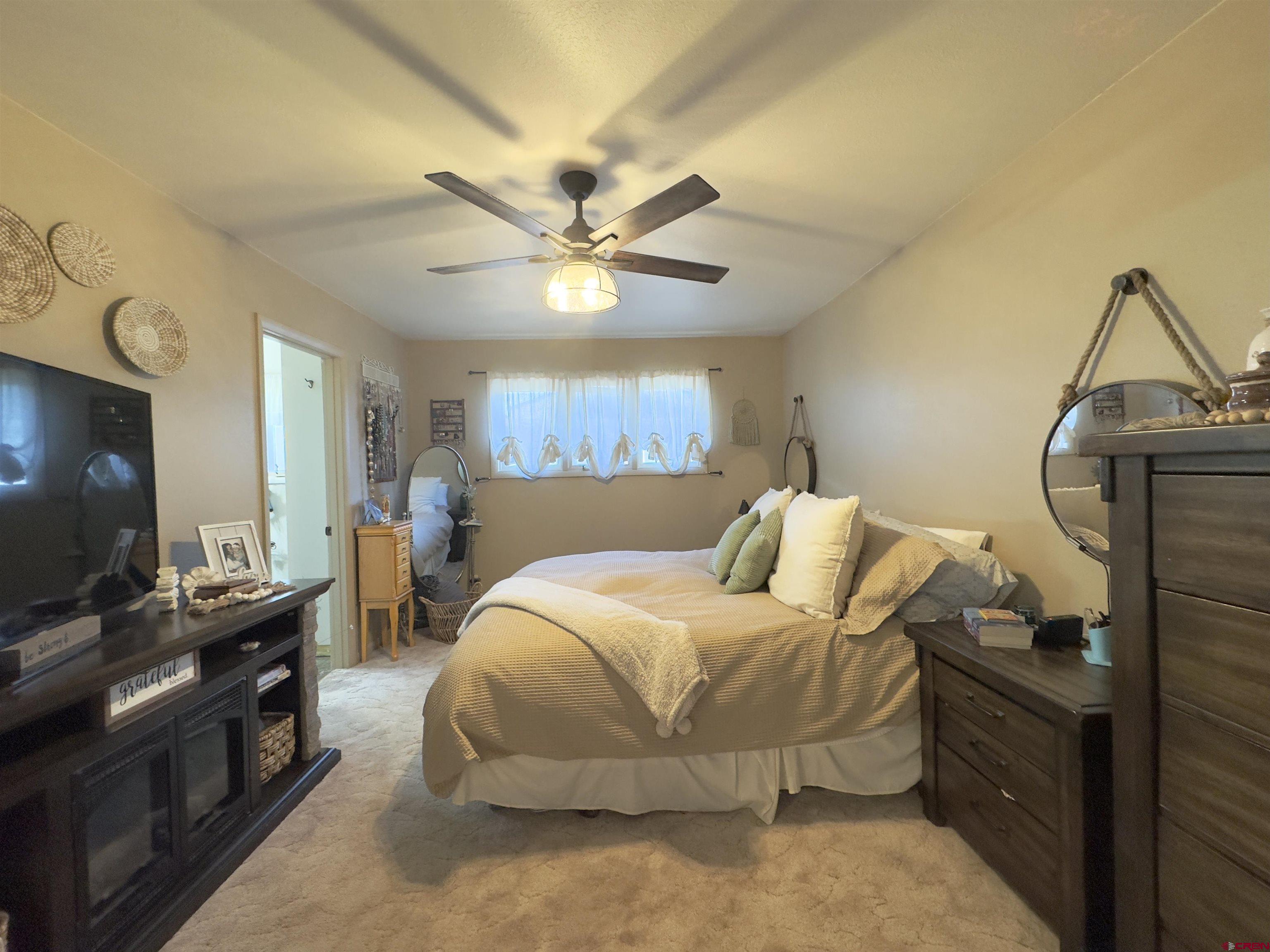 660 Columbia Avenue Del Norte, CO 81132 - Photo 17 of 31 a bedroom with a bed and a flat screen tv