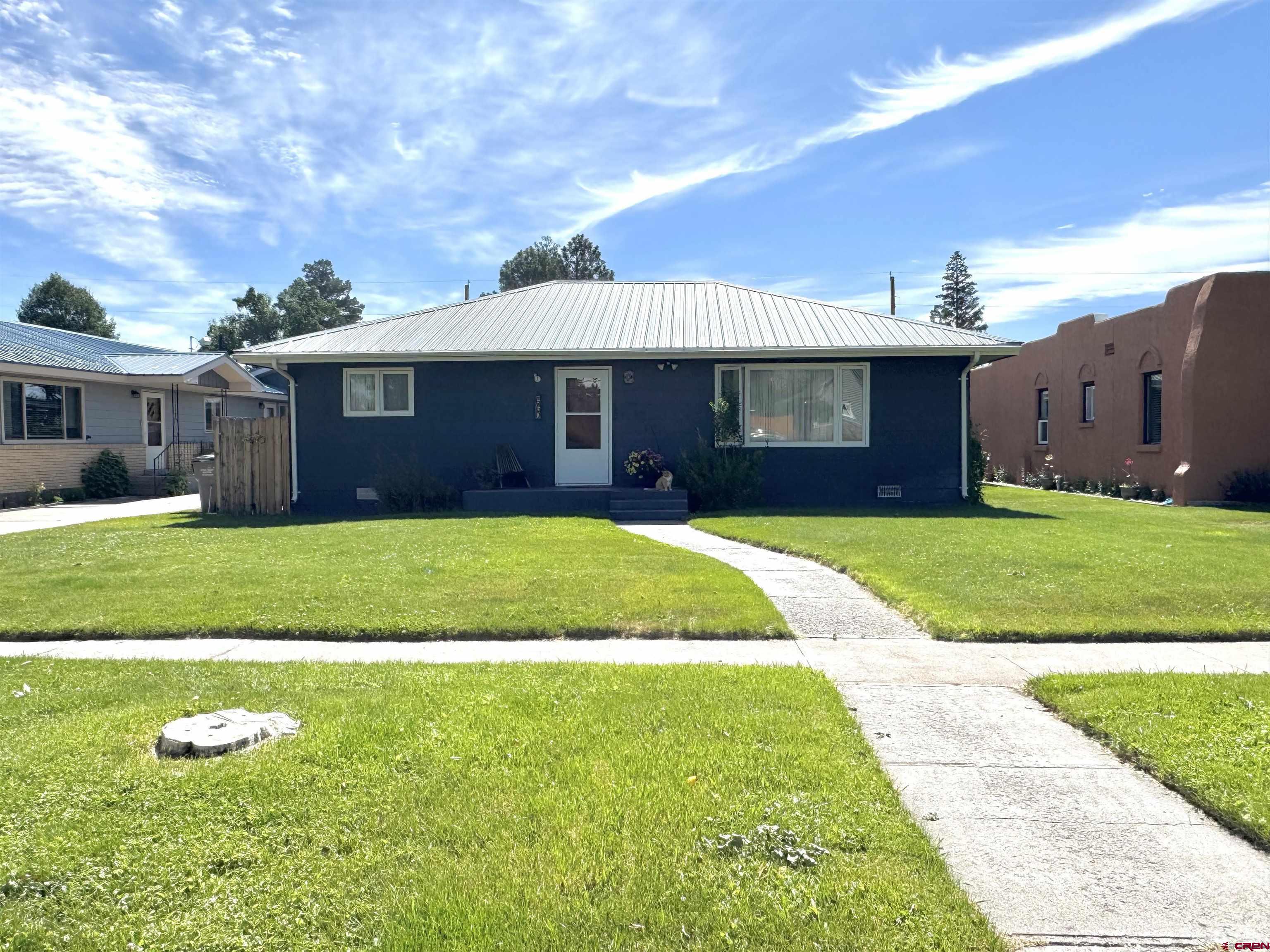 660 Columbia Avenue Del Norte, CO 81132 - Photo 2 of 31 a view of a house with a garden
