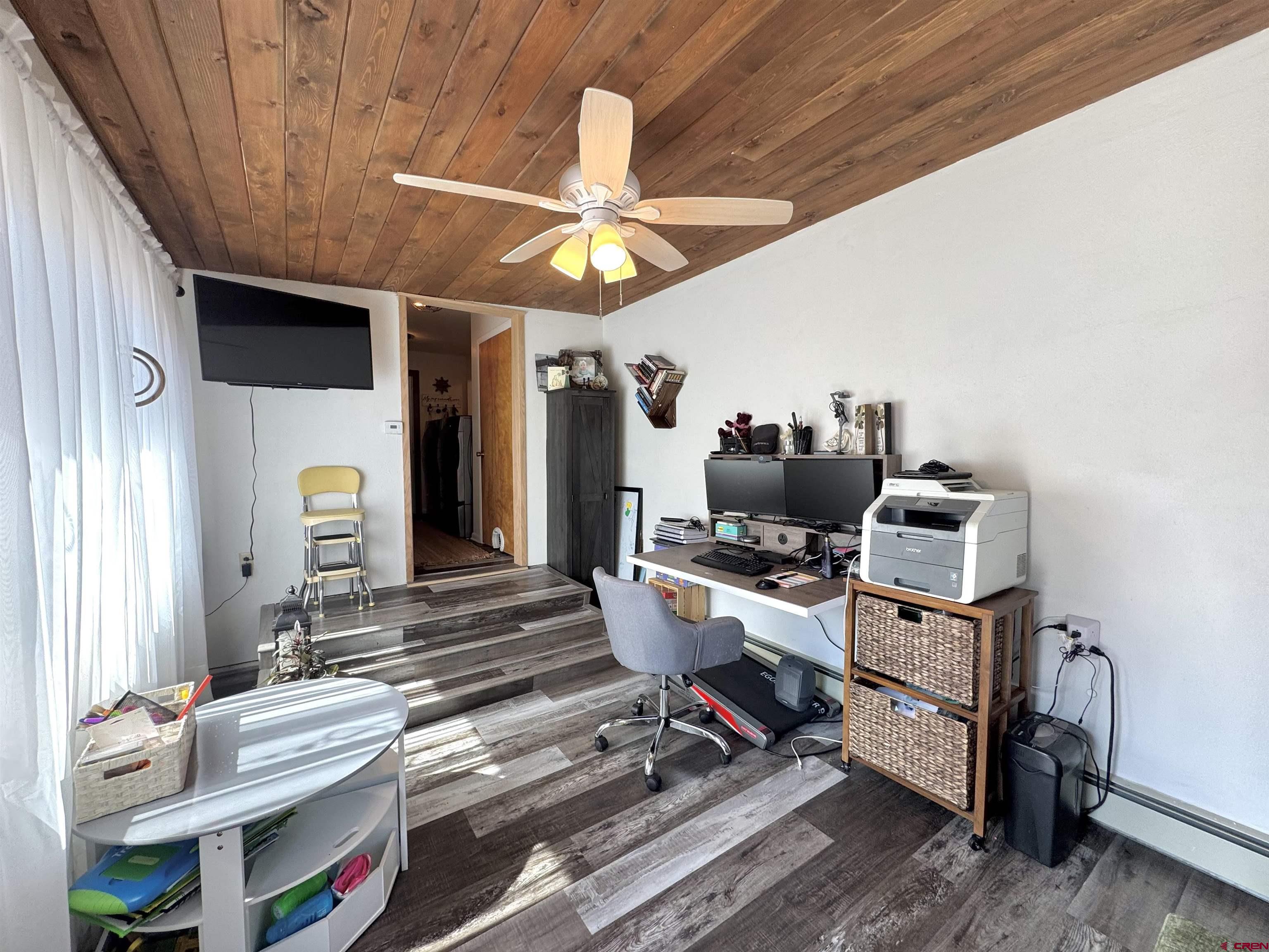 660 Columbia Avenue Del Norte, CO 81132 - Photo 24 of 31 a room with furniture and wooden floor