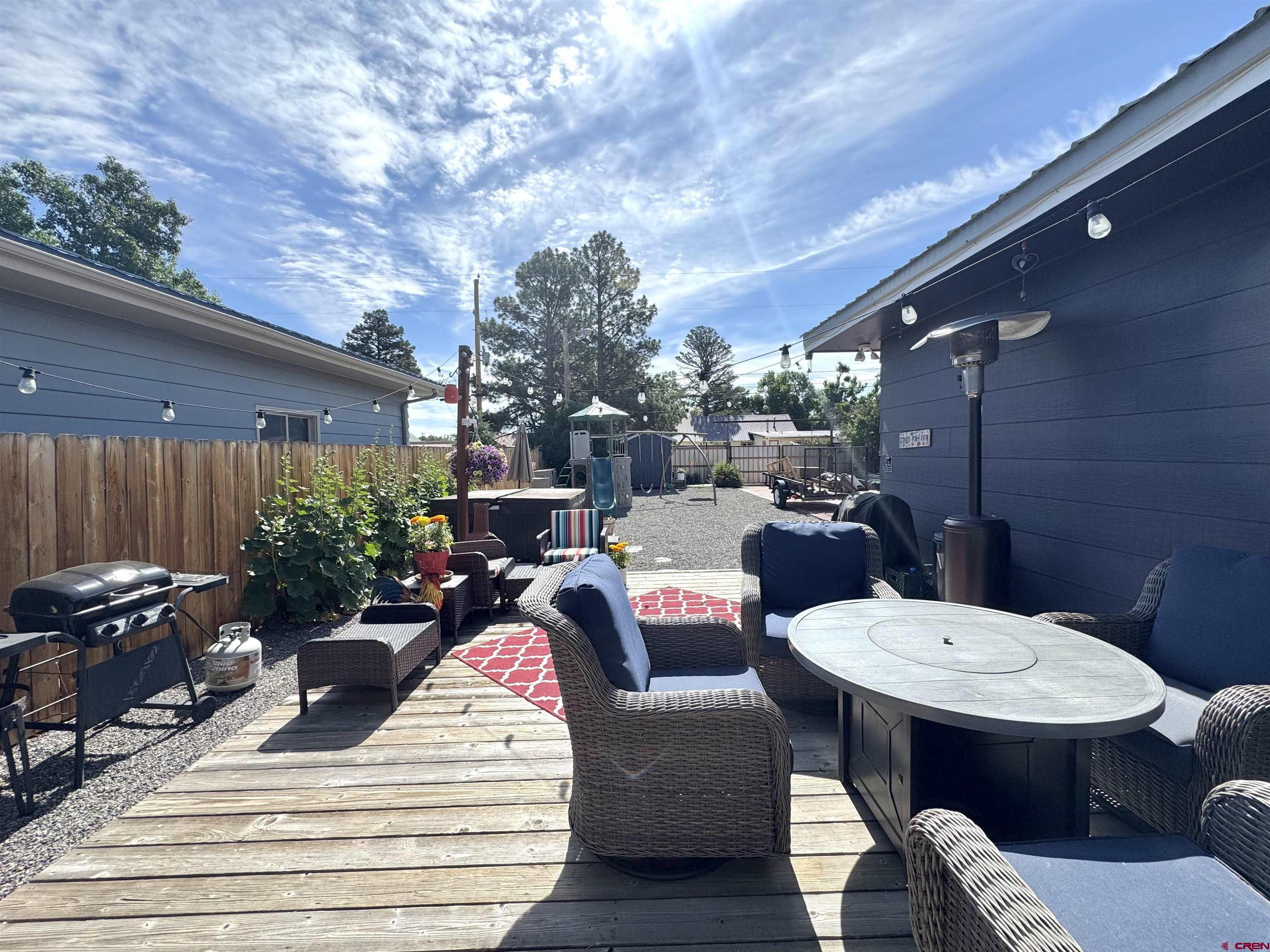 660 Columbia Avenue Del Norte, CO 81132 - Photo 26 of 31 a view of a patio with couches table and chairs and potted plants