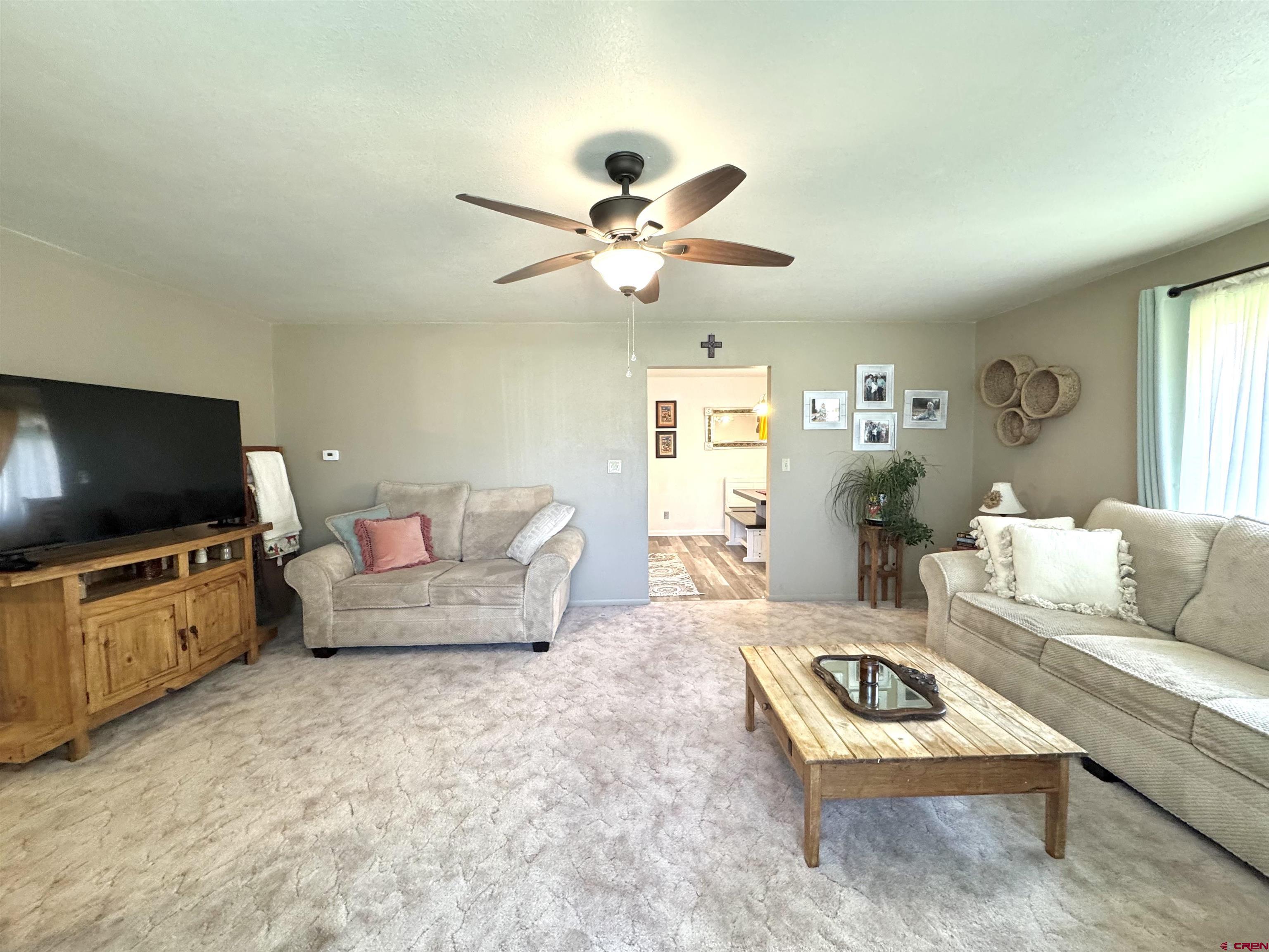 660 Columbia Avenue Del Norte, CO 81132 - Photo 7 of 31 a living room with furniture and a flat screen tv