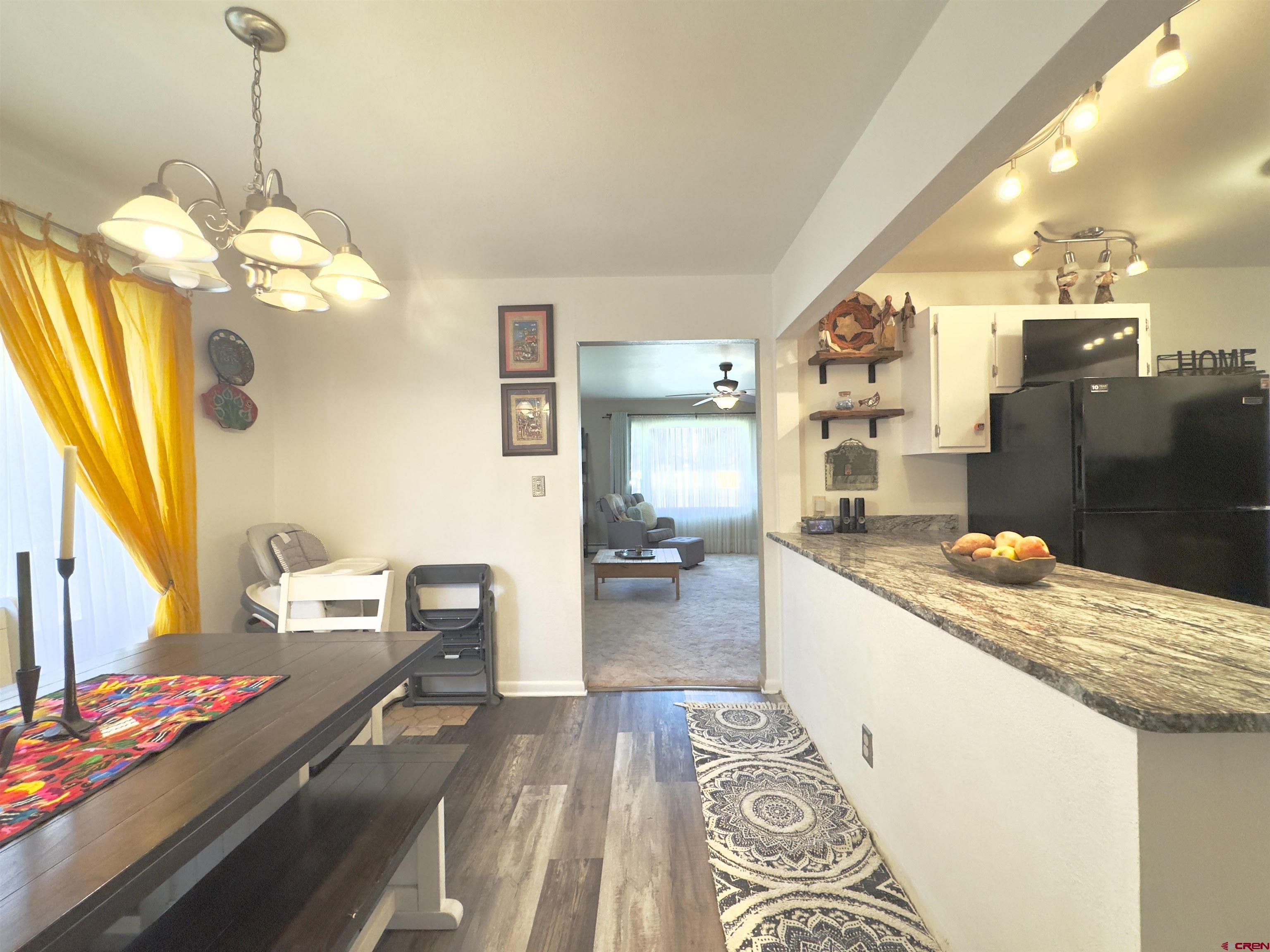 660 Columbia Avenue Del Norte, CO 81132 - Photo 8 of 31 a kitchen with stainless steel appliances granite countertop a sink dishwasher and a stove with wooden floor