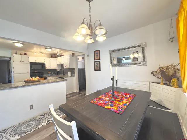 a living room with dining table and a table