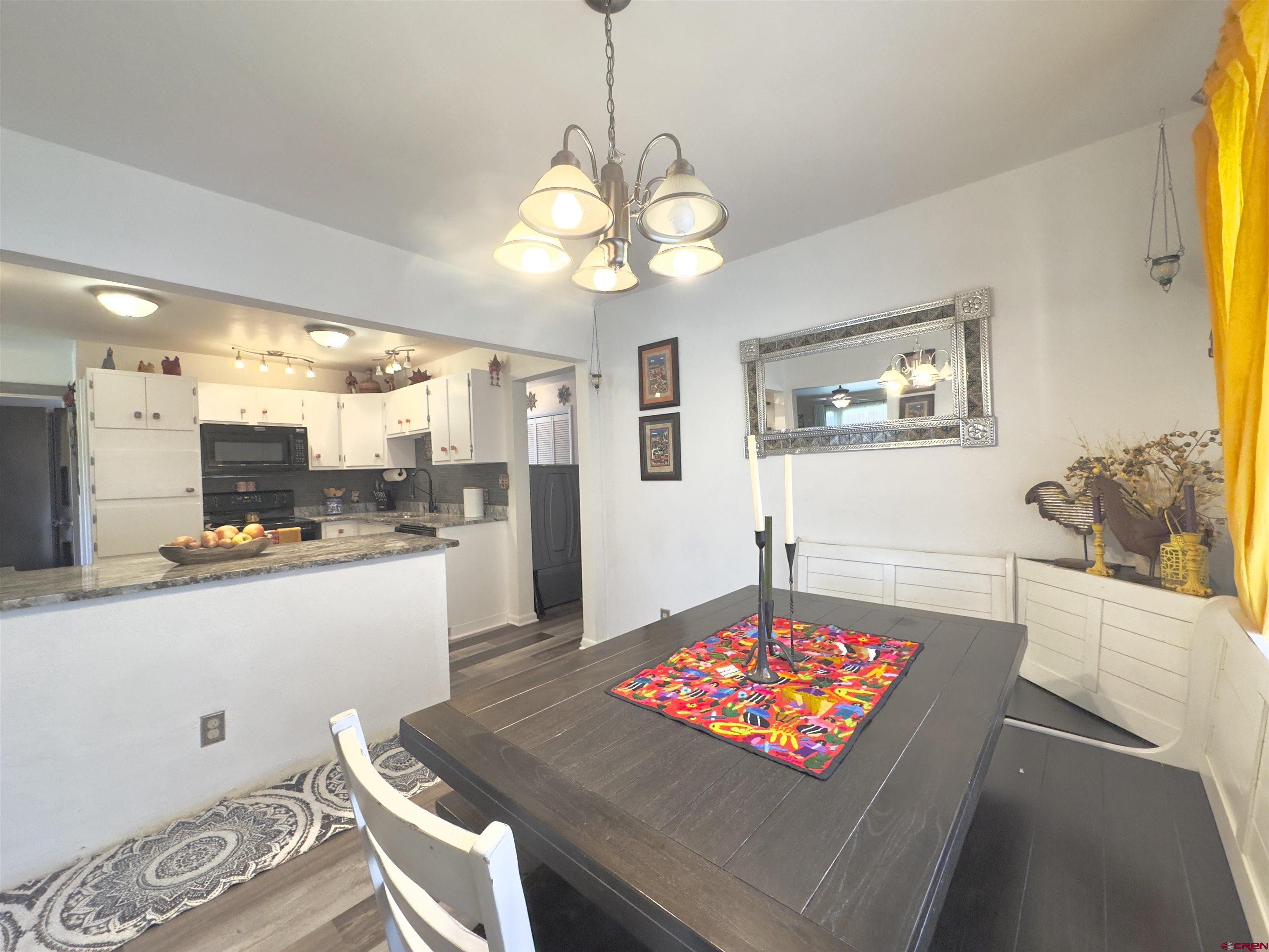 660 Columbia Avenue Del Norte, CO 81132 - Photo 9 of 31 a living room with dining table and a table
