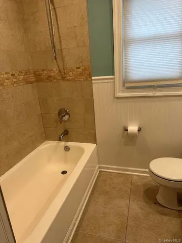 a bathroom with a sink a toilet and bathtub