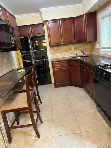 a kitchen with a stove a refrigerator and a sink