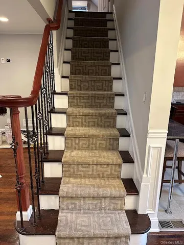 a view of entryway with wooden floor and lots of windows