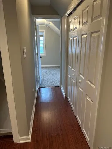 a view of hallway with wooden floor