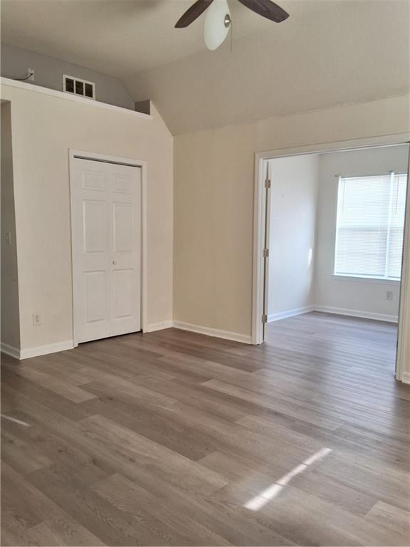 2909 Gala Trail Southwest Snellville, GA 30039 - Photo 12 of 22 an empty room with wooden floor cabinet and windows