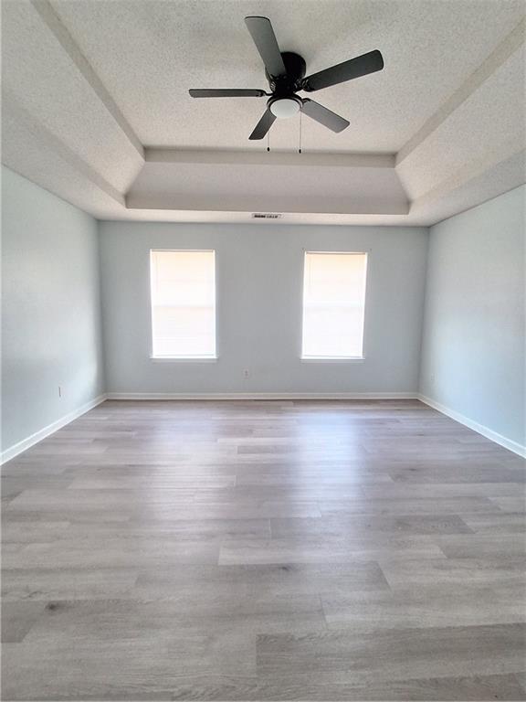 2909 Gala Trail Southwest Snellville, GA 30039 - Photo 14 of 22 an empty room with wooden floor fan and windows