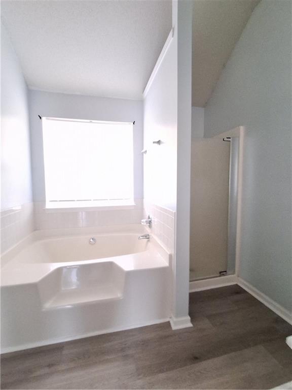2909 Gala Trail Southwest Snellville, GA 30039 - Photo 15 of 22 a bathroom with a bathtub and a shower