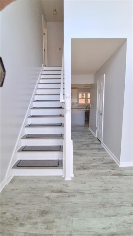 2909 Gala Trail Southwest Snellville, GA 30039 - Photo 2 of 22 a view of a hallway with wooden floor and staircase