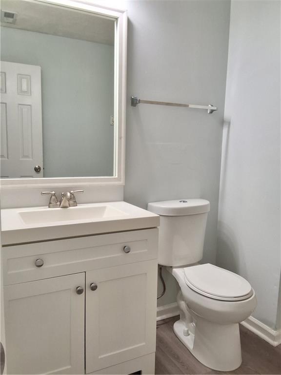 2909 Gala Trail Southwest Snellville, GA 30039 - Photo 9 of 22 a bathroom with a granite countertop toilet a sink and a mirror