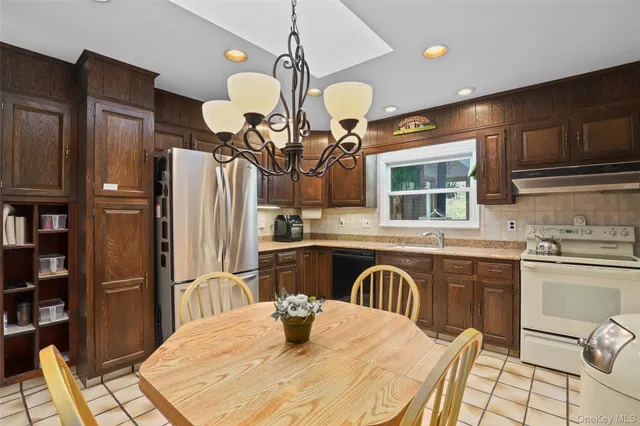 a kitchen with stainless steel appliances kitchen island granite countertop a sink and cabinets