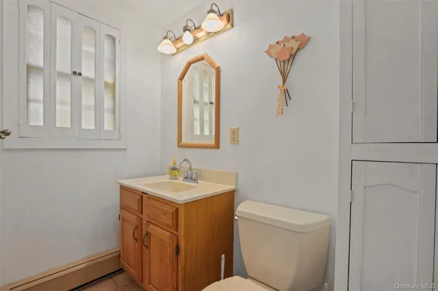 a bathroom with a double vanity sink toilet mirror and shower