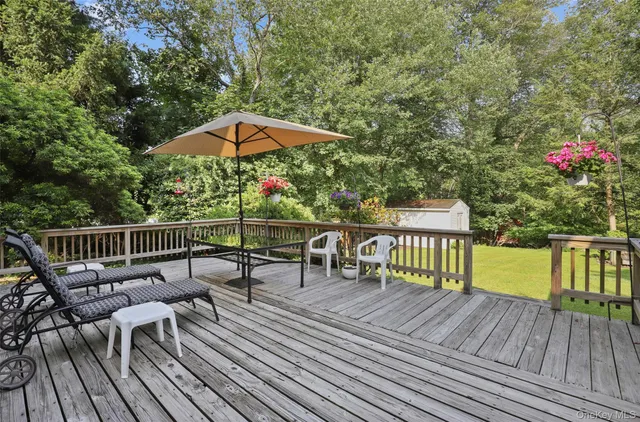 a front view of a house with a garden and trees