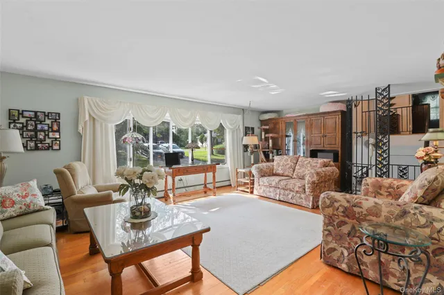 a dining room with furniture a chandelier and wooden floor