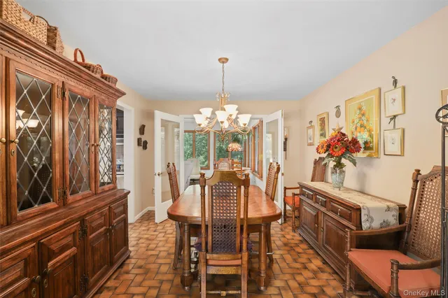 a view of a dining room with furniture and chandelier