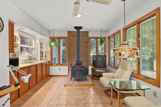 a kitchen with stainless steel appliances granite countertop a refrigerator a stove a sink dishwasher a dining table and chairs with wooden floor