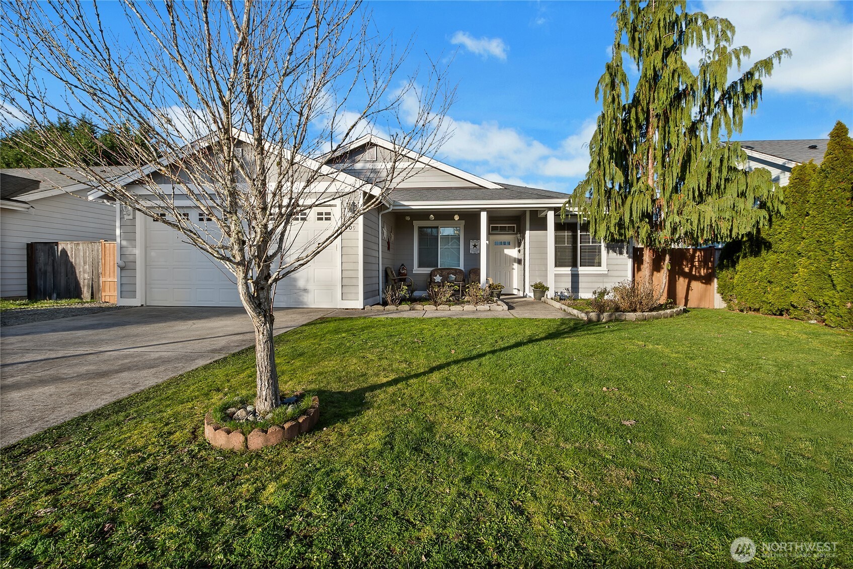 509 Balmer Street Southwest Orting, WA 98360 - Photo 2 of 22 a front view of a house with garden