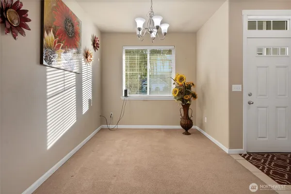 a view of a livingroom with a window and a chandelier