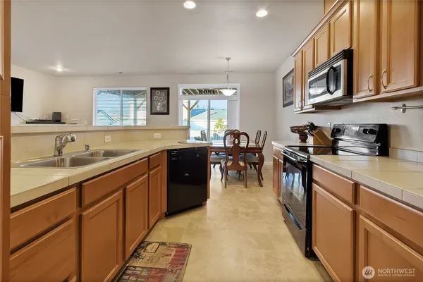 a kitchen with stainless steel appliances granite countertop a sink and cabinets