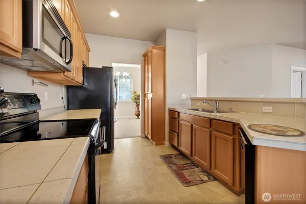 a kitchen with stainless steel appliances a stove and cabinets
