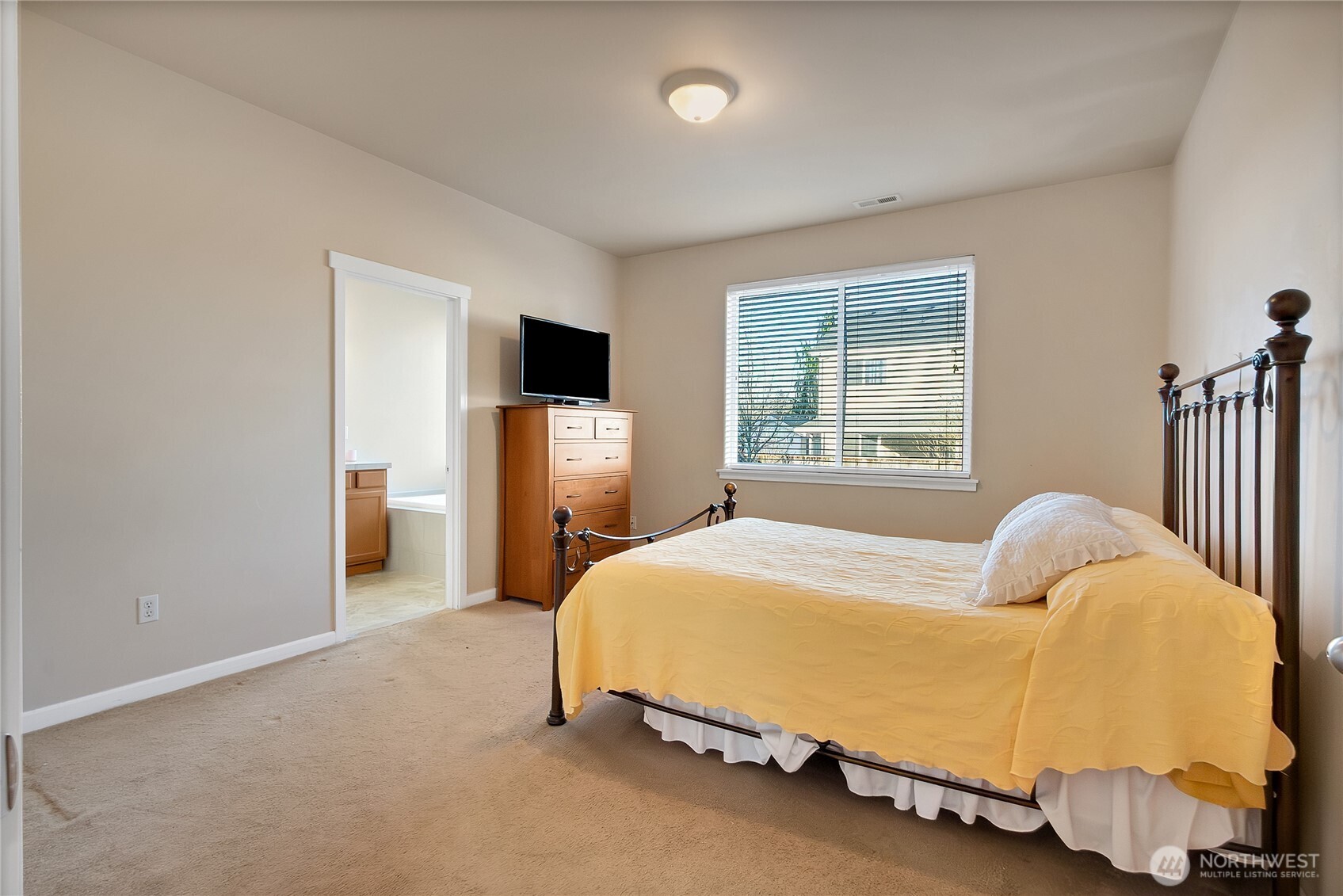 509 Balmer Street Southwest Orting, WA 98360 - Photo 9 of 22 a bedroom with a bed and wooden floor