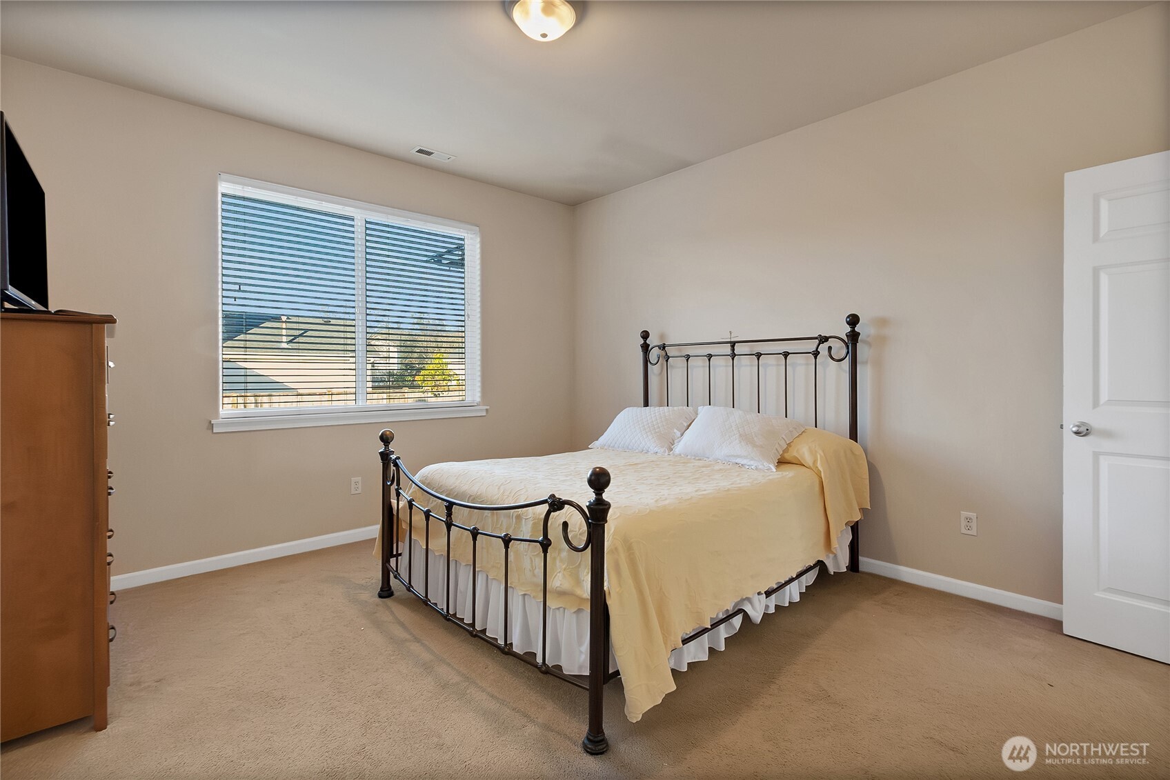 509 Balmer Street Southwest Orting, WA 98360 - Photo 10 of 22 a bed sitting in a bedroom next to a window
