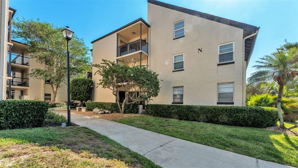 2025 Sylvester Road, Unit N305 Lakeland, FL 33803 - Photo 1 of 34 a view of a white house with a yard and plants