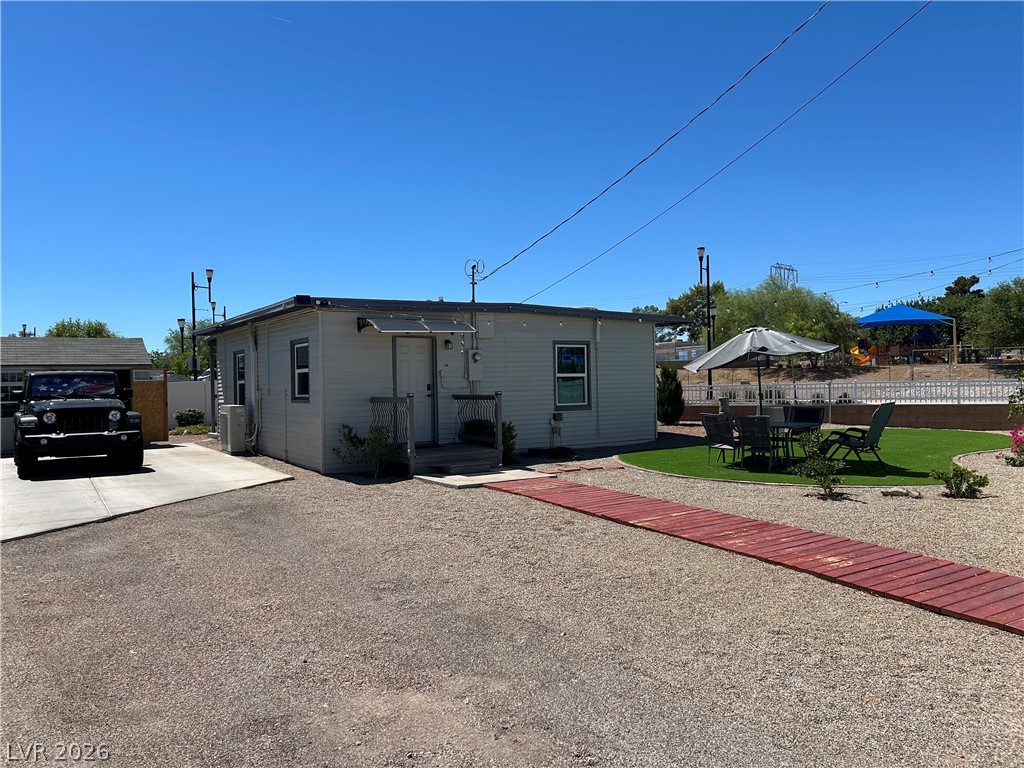116 West Basic Road Henderson, NV 89015 - Photo 2 of 39 A private outdoor space with artificial turf and a gravel yard, perfect for relaxation and recreation.