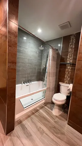 a bathroom with a toilet and a shower