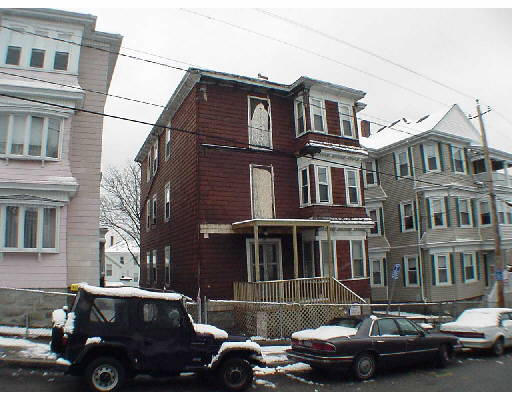 a front view of a building with car parked