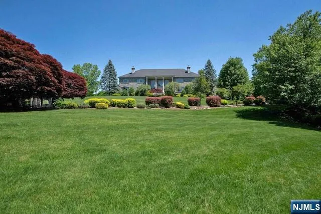a backyard of a house with lots of green space and trees