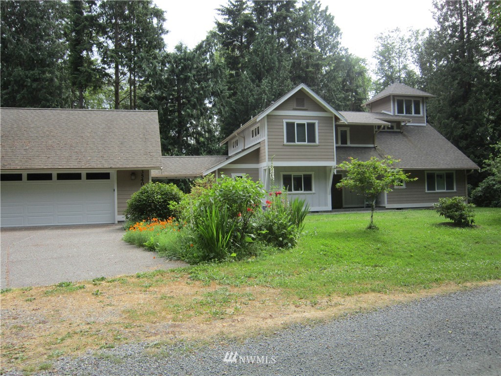 3540 7075 South Clinton, WA 98236 - Photo 1 of 25 a front view of a house with a yard and garage