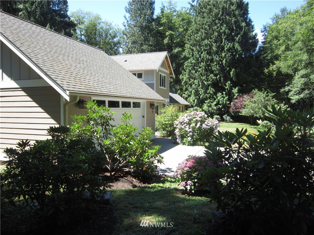 3540 7075 South Clinton, WA 98236 - Photo 2 of 25 a view of a house with a yard and garden