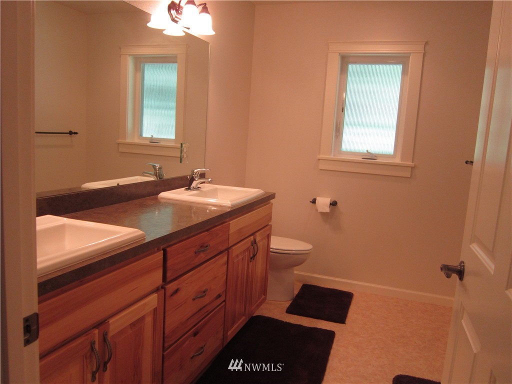 3540 7075 South Clinton, WA 98236 - Photo 12 of 25 a bathroom with a sink and a mirror