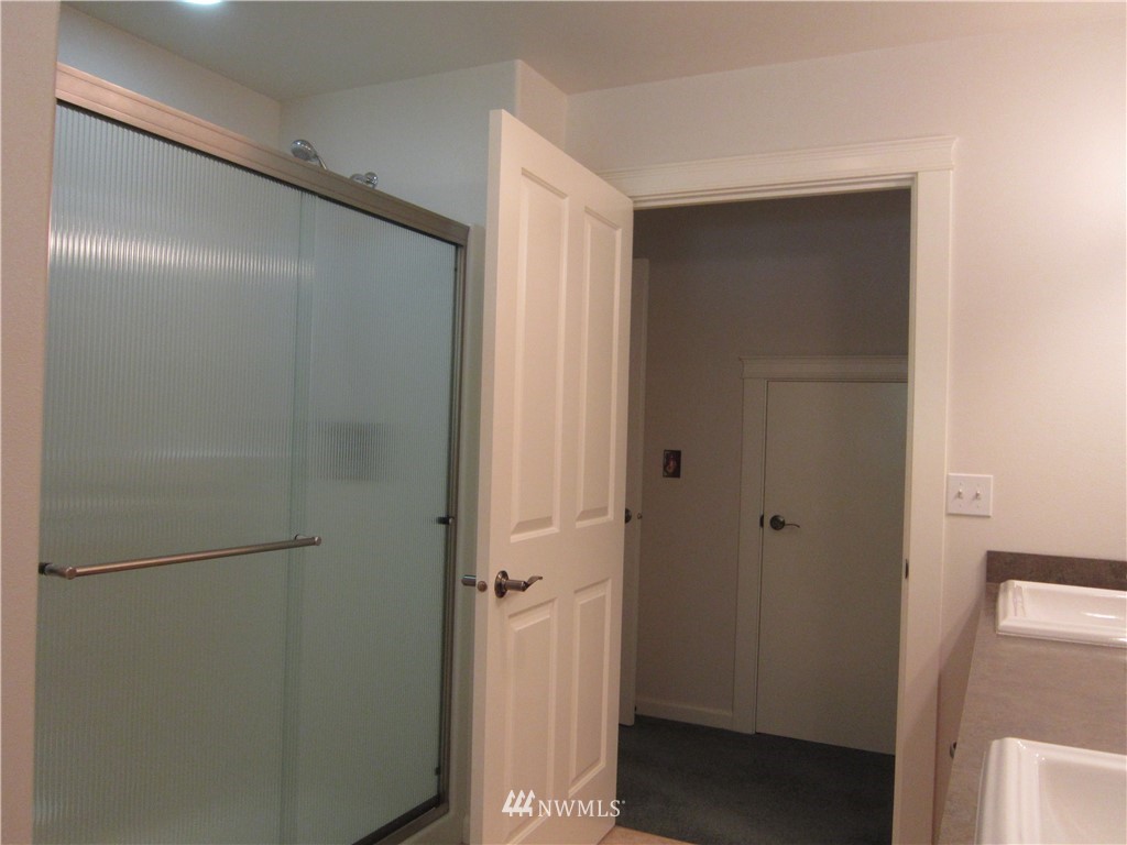 3540 7075 South Clinton, WA 98236 - Photo 13 of 25 a bathroom with a glass shower door