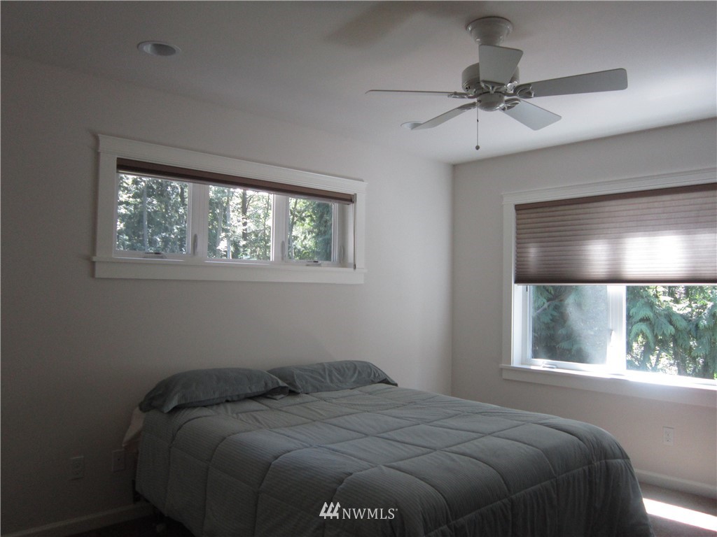 3540 7075 South Clinton, WA 98236 - Photo 15 of 25 a bed sitting in a bedroom next to a window