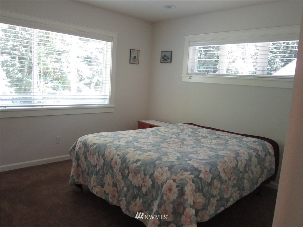 3540 7075 South Clinton, WA 98236 - Photo 16 of 25 a bed sitting in a bedroom next to a window