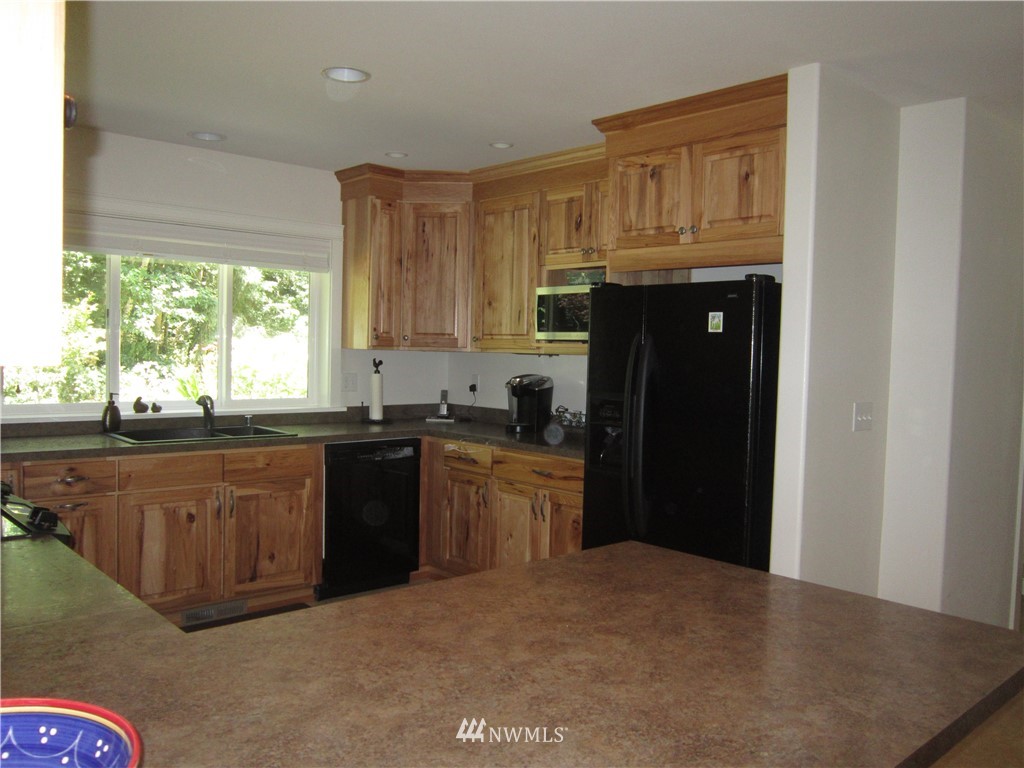 3540 7075 South Clinton, WA 98236 - Photo 5 of 25 a kitchen with granite countertop a refrigerator stove top oven and sink