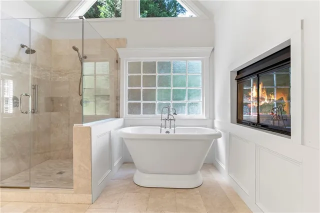 a spacious bathroom with a granite countertop sink a mirror and a shower