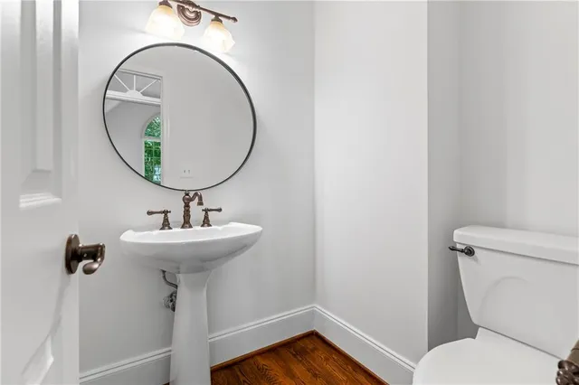 a kitchen with granite countertop a stove and a wooden floor