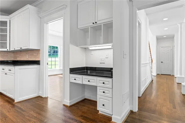 an empty room with a window and a ceiling fan